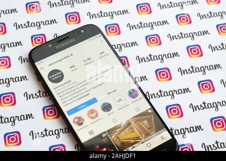 NY, USA - DECEMBER 4, 2019: Samsung mobile official instagram account on smartphone screen on paper instagram banner. Stock Photo