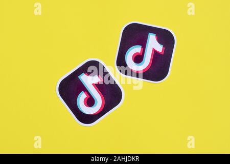 NY, USA - DECEMBER 5, 2019: Tiktok paper logo on yellow background. TikTok is a popular video-sharing social networking service owned by ByteDance Stock Photo