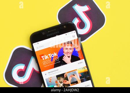 NY, USA - DECEMBER 5, 2019: Tiktok application on samsung smartphone screen on yellow background. TikTok is a popular video-sharing social networking Stock Photo