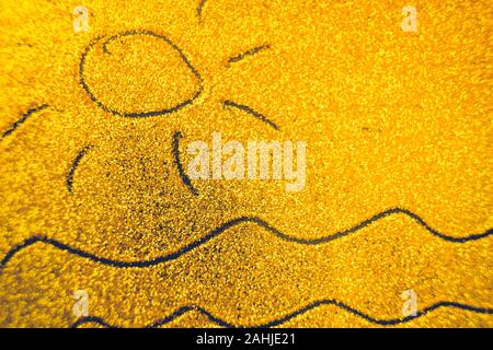 Hand drawn sun and sea waves on golden sandy background. Stock Photo