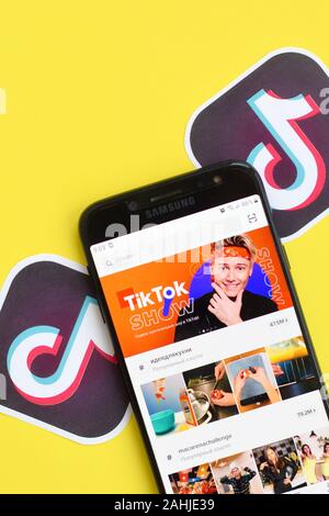 NY, USA - DECEMBER 5, 2019: Tiktok application on samsung smartphone screen on yellow background. TikTok is a popular video-sharing social networking Stock Photo