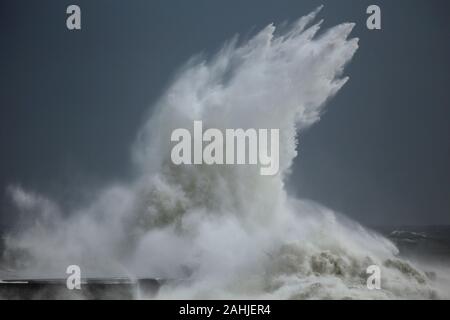 Stormy waves splash against ocean pier from northern Portugal. Stock Photo