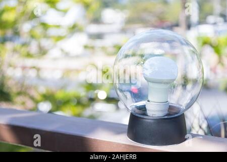 light bulb circular perfect on balcony in the morning, but it still turn off Stock Photo
