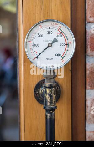 old Pressure gas measuring that use to be decoration at the door in cafe Stock Photo
