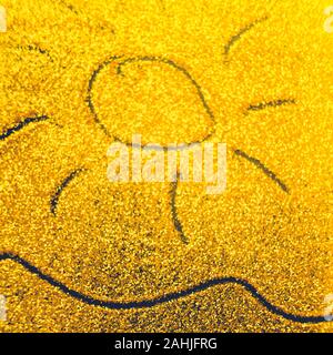 Hand drawn sun and sea wave on golden sandy background. Stock Photo