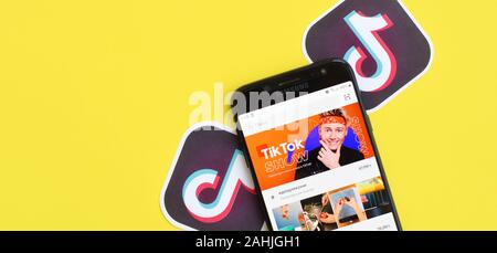 NY, USA - DECEMBER 5, 2019: Tiktok application on samsung smartphone screen on yellow background. TikTok is a popular video-sharing social networking Stock Photo