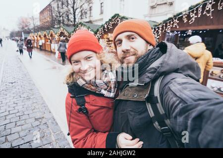 Young Caucasian couple making selfie at the Christmas market in Kosice, Slovakia