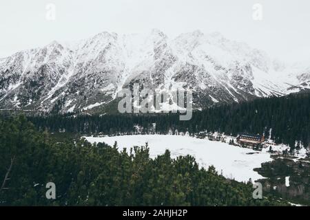 View over Popradske Pleso and snowcapped High Tatra mountains in winter. Stock Photo