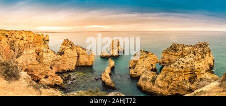 Panorama of Ponta da Piedade cliffs at sunset near Lagos, Portugal. Beautiful seascape with natural rock formations in the Algarve, portuguese tourist