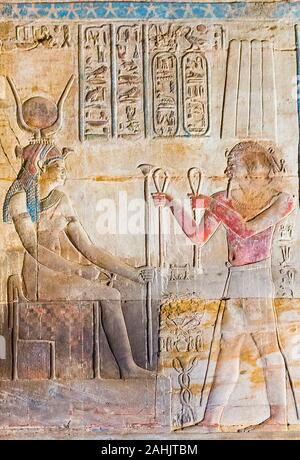 UNESCO World Heritage, Thebes in Egypt, Karnak site, temple of Opet. Under a sky full of stars, the king offers clothes to Isis the Great. Stock Photo