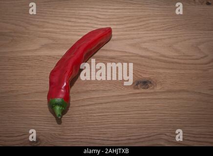 Peppers on wooden table top ready for preparation Stock Photo