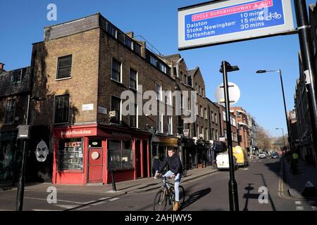 A view of cyclist and Cycle Superhighway sign on Pitfield Street on sunny autumn day in Hoxton North London N1 UK England Great Britain  KATHY DEWITT Stock Photo