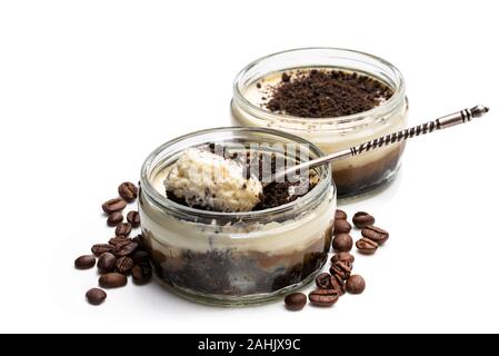Layered  creamy cappuccino cheesecakes in glass jars isolated on white Stock Photo