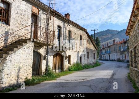 Old houses on the main street in the little village of Agios Germanos near Lake Prespa in the Prespes Municipality, Macedonia, Northern Greece. Stock Photo