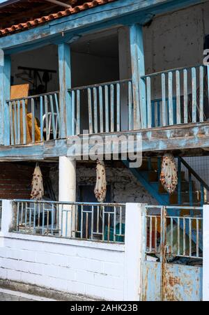 Wooden balconies and fishing nets in the fishing village of Psarades on Lake Prespa in Macedonia, Northern Greece. Stock Photo