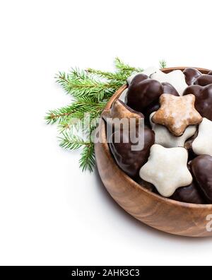 Sugar  and chocolate glazed seasonal spiced cookies in wooden bowl isolated on white Stock Photo
