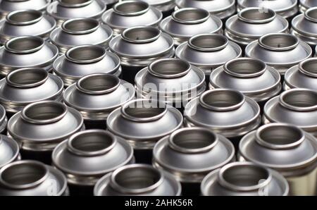 A large number of aerosol cans on a black background Stock Photo