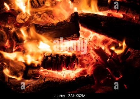 A glowing camp fire providing comfort and light during a cool summer night in a national park. Stock Photo