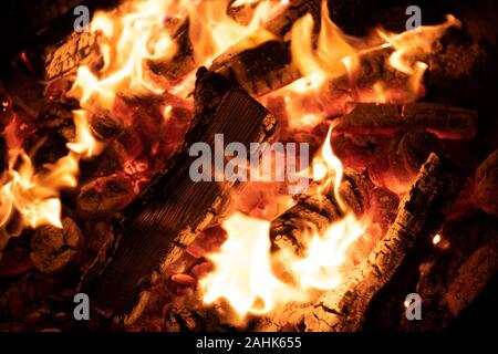 A glowing camp fire providing comfort and light during a cool summer night in a national park. Stock Photo