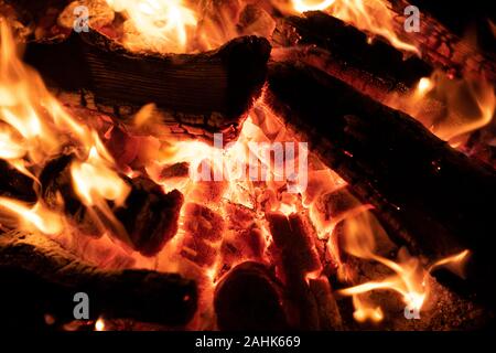 A glowing camp fire providing comfort and light during a cool summer night in a national park. Stock Photo