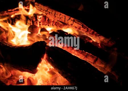 A glowing camp fire providing comfort and light during a cool summer night in a national park. Stock Photo