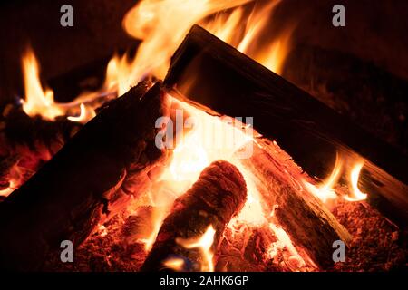 A glowing camp fire providing comfort and light during a cool summer night in a national park. Stock Photo