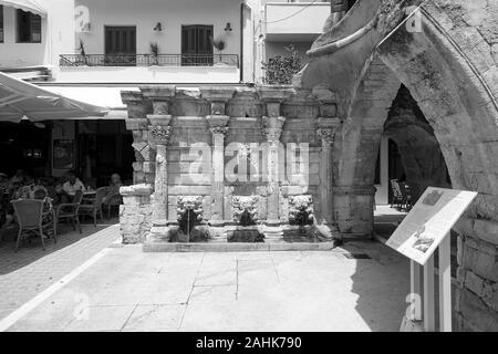 Viewed here in monochrome format is the Rimondi Fountain in Rethymnon, a popular place of interest on the tourist trail in Crete. Stock Photo