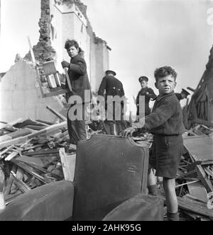 Group of People and Wreckage of Buildings during World War II Bombing of London, England, UK, photograph by Toni Frissell, January 1945 Stock Photo