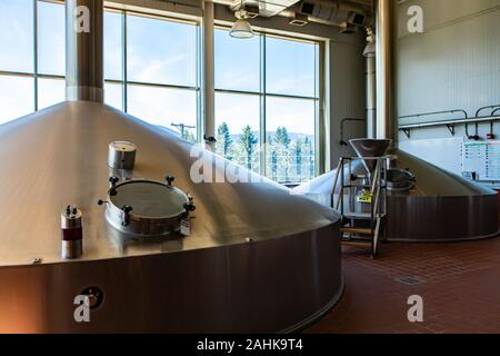 Mash lauter tun, two stainless steel big vessels, Brewing tank top with glass manway door, Modern brewhouse, brewery room in big beer factory machines Stock Photo