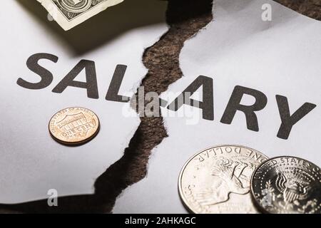 The inscription salary is torn in half. Concept on the theme of the financial crisis and falling incomes Stock Photo