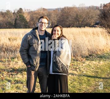 Young caucasian couple pose for a photo while no a walk in park. November, 25, 2019, Berks County, Pennsylvania, USA. Stock Photo