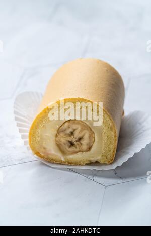 Swiss Banana Roll Cake Sponge / Rolled or Roulade Cake Ready to Eat. Traditional Dessert. Stock Photo