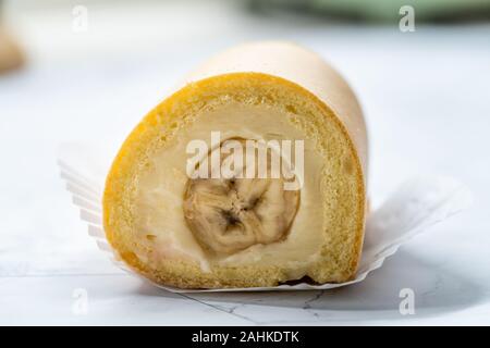 Swiss Banana Roll Cake Sponge / Rolled or Roulade Cake Ready to Eat. Traditional Dessert. Stock Photo