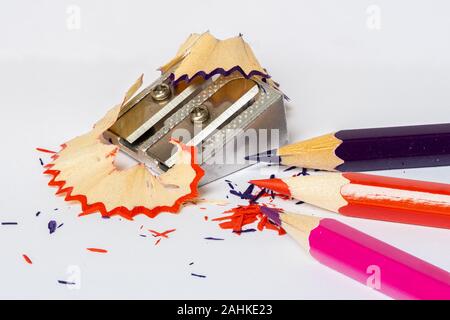 Color pencils, sharpener and shavings isolated on a white background Stock Photo