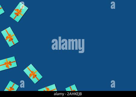 Holiday card. Mint gift boxes with orange ribbon on classic blue background. Place to text. Stock Photo