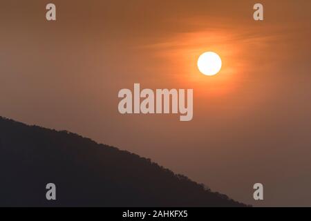 Sunset over trees, Laos Stock Photo