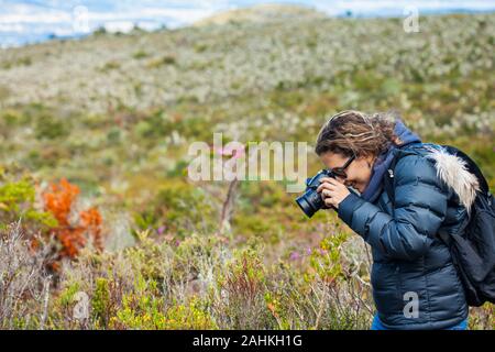 Young woman exploring the nature of a beautiful paramo at the department of Cundinamarca in Colombia Stock Photo