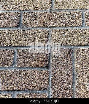 Crack running through bricks and mortar of house wall, UK Stock Photo