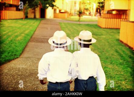 Two boys wearing similar clothes are walking. Stock Photo