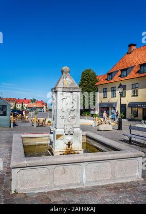 Small town fountain in the centre of the Hanseatic town of Visby, Gotland, Sweden on 20 July 2019 Stock Photo