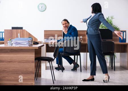 The two employees doing sport exercises in the office Stock Photo