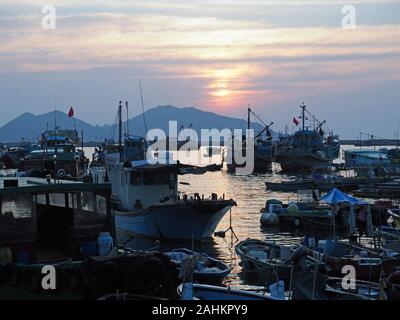 View of boats anchored in the harbour at Cheung Chau Island in Hong Kong at sunset