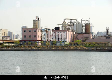 Old factory buildings stand by the Haihe river in Binhai district, Tianjin, China Stock Photo