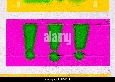 Exclamation points painted as an icon on a wall. Stock Photo