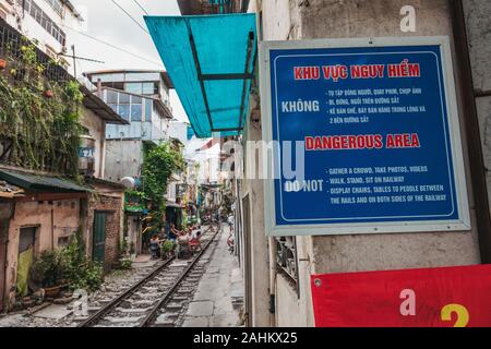 A warning sign in Vietnamese and English at the start of Hanoi's infamous Train Street, Ngo 224 Le Duan, in the Old Quarter Stock Photo