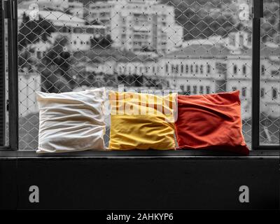 Three colorful pillows on the window, with city in the background, Rio de Janeiro, Brazil Stock Photo