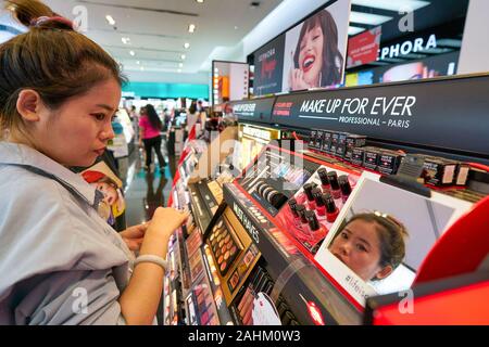 SINGAPORE - APRIL 03, 2019: woman shopping for cosmetics products at Sephora store in Singapore. Stock Photo