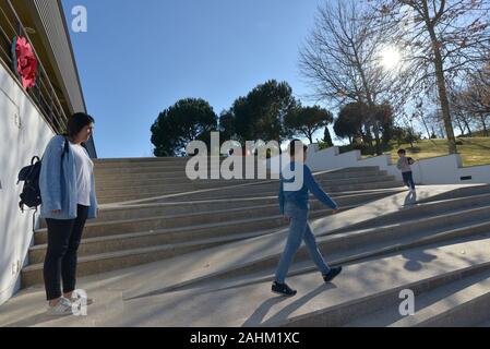 mother and her 2 kids walking on a staircase Stock Photo
