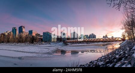 View of Calgary's skyline on a cold winter day. Bow River and the Peace Bridge are visible in the image.  Office towers in the downtown core are also. Stock Photo