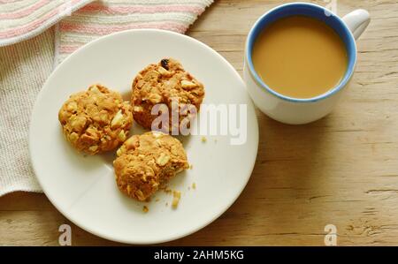 cereal cookie and coffee cup on wooden table Stock Photo